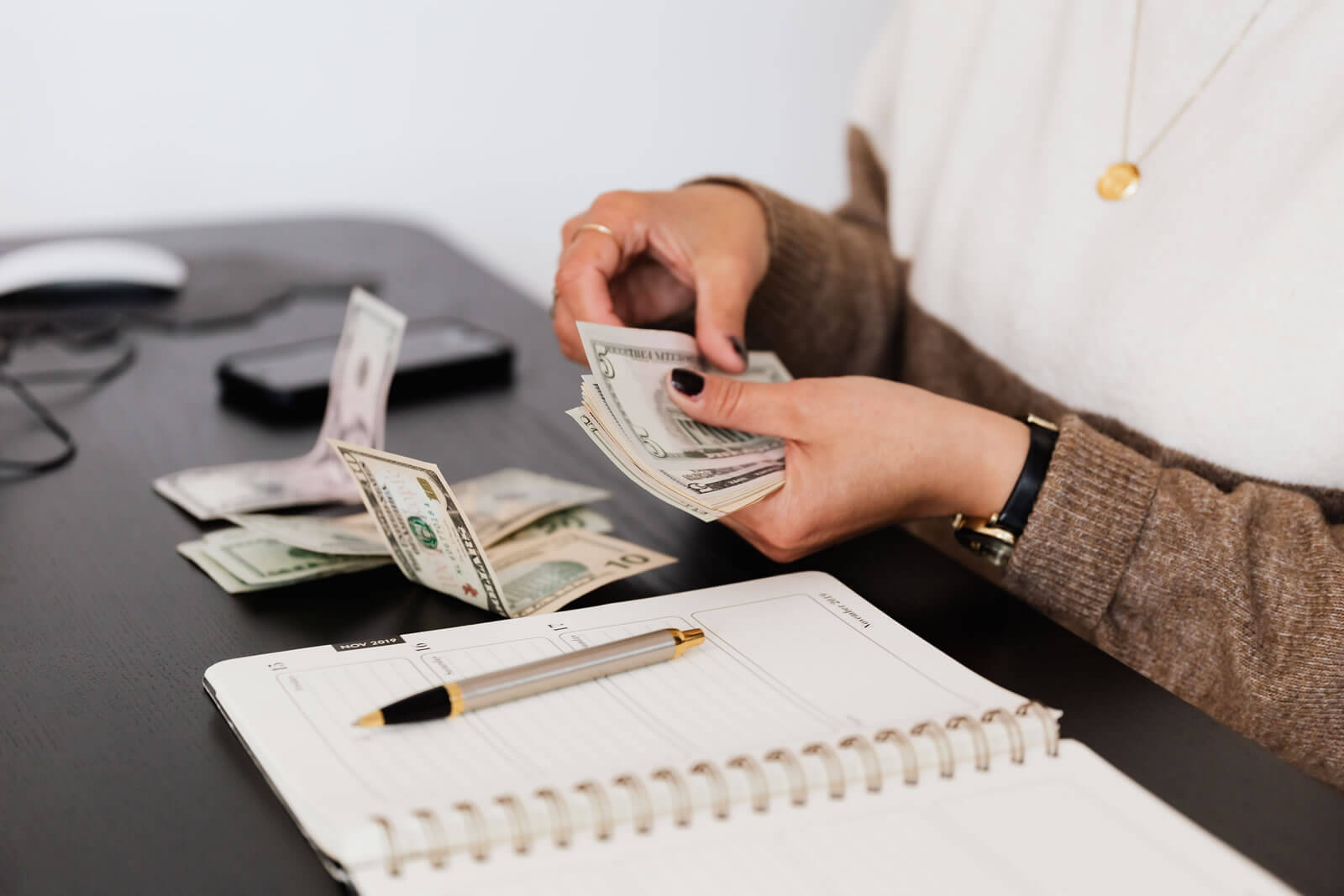 Person counting money and making notes